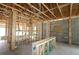 An unfinished interior of a house with exposed wooden framing and visible electrical wiring at 10648 Crescent Creek Xing, Parrish, FL 34219