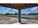 Unfinished lanai view of a pond with clear blue sky and surrounding lush greenery at 10648 Crescent Creek Xing, Parrish, FL 34219