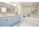 Bright bathroom featuring double vanity, soaking tub, and modern fixtures at 11 Baymont St # 505, Clearwater Beach, FL 33767