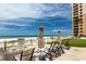 Relaxing ocean view and lounge chairs on a patio at a beachfront condominium at 11 Baymont St # 505, Clearwater Beach, FL 33767