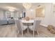 This dining room showcases a modern chandelier and a white dining table with comfortable seating for six at 11 Baymont St # 505, Clearwater Beach, FL 33767