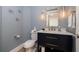 Stylish half-bathroom with a modern vanity, designer mirror, and elegant lighting at 11 Baymont St # 505, Clearwater Beach, FL 33767