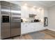 Modern kitchen featuring stainless steel appliances, white cabinetry, and hardwood flooring at 11 Baymont St # 505, Clearwater Beach, FL 33767