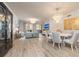 Bright and airy living room featuring stylish furnishings and a beautiful chandelier over the dining area at 11 Baymont St # 505, Clearwater Beach, FL 33767