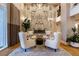 Inviting lobby with chairs around fireplace and patterned marble wall feature at 11 Baymont St # 505, Clearwater Beach, FL 33767