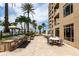 Outdoor kitchen and dining area features stainless steel grills and elegant patio furniture at 11 Baymont St # 505, Clearwater Beach, FL 33767