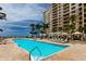 Stunning waterfront pool with lounge chairs and palm trees at luxury beachfront condominium at 11 Baymont St # 505, Clearwater Beach, FL 33767