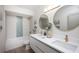Bright bathroom featuring a dual sink vanity, bathtub, and shower combo with tile surround at 11322 Carrollwood Dr, Tampa, FL 33618