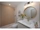 Stylish bathroom featuring modern vanity, round mirror, and elegant tiled shower with wood accents at 11322 Carrollwood Dr, Tampa, FL 33618