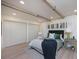 Cozy bedroom with exposed beams, neutral color palette, and ample closet space at 11322 Carrollwood Dr, Tampa, FL 33618