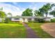 Charming single-story home with beautiful landscaping and a welcoming front entrance at 11322 Carrollwood Dr, Tampa, FL 33618