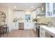 Well-lit kitchen with stainless steel appliances, white cabinets, and quartz countertops at 11322 Carrollwood Dr, Tampa, FL 33618