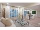 Bright and airy living room with large windows and seamless access to the dining area at 11322 Carrollwood Dr, Tampa, FL 33618