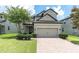 Charming two-story home features a well-manicured lawn, brick paved driveway and an attached two-car garage at 12382 Tibbetts St, Odessa, FL 33556
