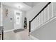Bright foyer with neutral walls, wood-look tile flooring, a stairway and a decorative shelf at 12382 Tibbetts St, Odessa, FL 33556