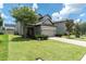 Traditional two-story home with well-maintained landscaping, brick driveway and a two-car garage at 12382 Tibbetts St, Odessa, FL 33556