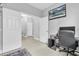 Hallway with door openings to rooms and a mounted television on the wall at 12382 Tibbetts St, Odessa, FL 33556