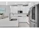 Bright kitchen features white cabinets, stainless steel appliances, and granite countertops at 12382 Tibbetts St, Odessa, FL 33556