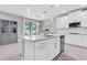 Spacious kitchen with a center island, stainless steel appliances, and ample cabinet space at 12382 Tibbetts St, Odessa, FL 33556
