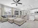 Bright and airy living room with a large sectional sofa, tile floors and lots of natural light at 12382 Tibbetts St, Odessa, FL 33556