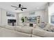 Comfortable living room showcasing a large sectional sofa, entertainment center, and a cozy ambiance at 12382 Tibbetts St, Odessa, FL 33556