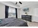 This spacious main bedroom features stylish black furnishings and a TV for relaxation at 12382 Tibbetts St, Odessa, FL 33556