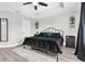 Well-lit main bedroom featuring a stylish bed, neutral walls, and minimalist decor at 12382 Tibbetts St, Odessa, FL 33556
