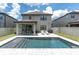 Beautiful pool area with an outdoor kitchen, patio seating, and a relaxing ambiance at 12382 Tibbetts St, Odessa, FL 33556