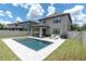 Private pool with lounge chairs, a grill and a covered patio in the backyard of this lovely home at 12382 Tibbetts St, Odessa, FL 33556