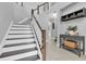 Elegant staircase with wooden handrails and white risers, complemented by neutral decor at 12382 Tibbetts St, Odessa, FL 33556