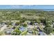 An aerial view showcasing a neighborhood with lush greenery and waterfront access at 1304 Cedar Ct, Tarpon Springs, FL 34689