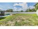 Large backyard with a sparkling pool and a privacy fence, perfect for outdoor enjoyment at 1304 Cedar Ct, Tarpon Springs, FL 34689
