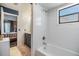 Bathroom featuring a bathtub, shower, and modern fixtures at 1304 Cedar Ct, Tarpon Springs, FL 34689