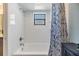 Bright bathroom featuring a tub and shower combination with neutral walls and modern fixtures at 1304 Cedar Ct, Tarpon Springs, FL 34689