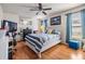 Comfortable bedroom featuring hardwood floors, ample natural light, and a ceiling fan at 1304 Cedar Ct, Tarpon Springs, FL 34689
