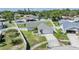 Exterior view of a well-maintained home with a green lawn and fenced yard in a sunny neighborhood at 1304 Cedar Ct, Tarpon Springs, FL 34689
