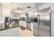 A modern kitchen with stainless steel appliances, white cabinets, and ample counter space at 1304 Cedar Ct, Tarpon Springs, FL 34689