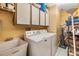 Functional laundry room with white cabinets, a utility sink, and washer and dryer at 1304 Cedar Ct, Tarpon Springs, FL 34689