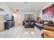 Cozy living room featuring tile flooring, a comfortable seating arrangement, and bright natural light at 1304 Cedar Ct, Tarpon Springs, FL 34689