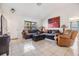 Cozy living room with comfortable seating, a large window, and stylish decor on tile flooring at 1304 Cedar Ct, Tarpon Springs, FL 34689