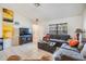 Inviting living room with tile flooring, a dark sofa, and natural light from a window at 1304 Cedar Ct, Tarpon Springs, FL 34689