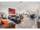 Open concept living and dining room with tile flooring, large windows, and access to the kitchen at 1304 Cedar Ct, Tarpon Springs, FL 34689