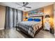 Relaxing main bedroom featuring hardwood flooring, a ceiling fan, and soft natural light at 1304 Cedar Ct, Tarpon Springs, FL 34689