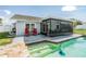 Outdoor pool and patio with a screened-in lanai for relaxing and entertaining at 1304 Cedar Ct, Tarpon Springs, FL 34689