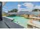 Beautiful pool with stone detailing and a lush, private backyard setting at 1304 Cedar Ct, Tarpon Springs, FL 34689