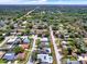 Extensive aerial view showcasing a residential neighborhood with mature trees, manicured lawns, and diverse home styles at 13186 Linden Place Dr, Seminole, FL 33776