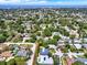 Panoramic aerial shot showing a residential area with many homes interspersed among lush greenery and trees at 13186 Linden Place Dr, Seminole, FL 33776