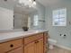 Bathroom featuring a vanity with drawers, a sink, a toilet and a large mirror at 13186 Linden Place Dr, Seminole, FL 33776