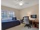 Bedroom with a twin bed, desk, and a window offering natural light, perfect for a home office at 13186 Linden Place Dr, Seminole, FL 33776
