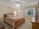 Bright bedroom with a large window, comfortable bed, and neutral walls at 13186 Linden Place Dr, Seminole, FL 33776